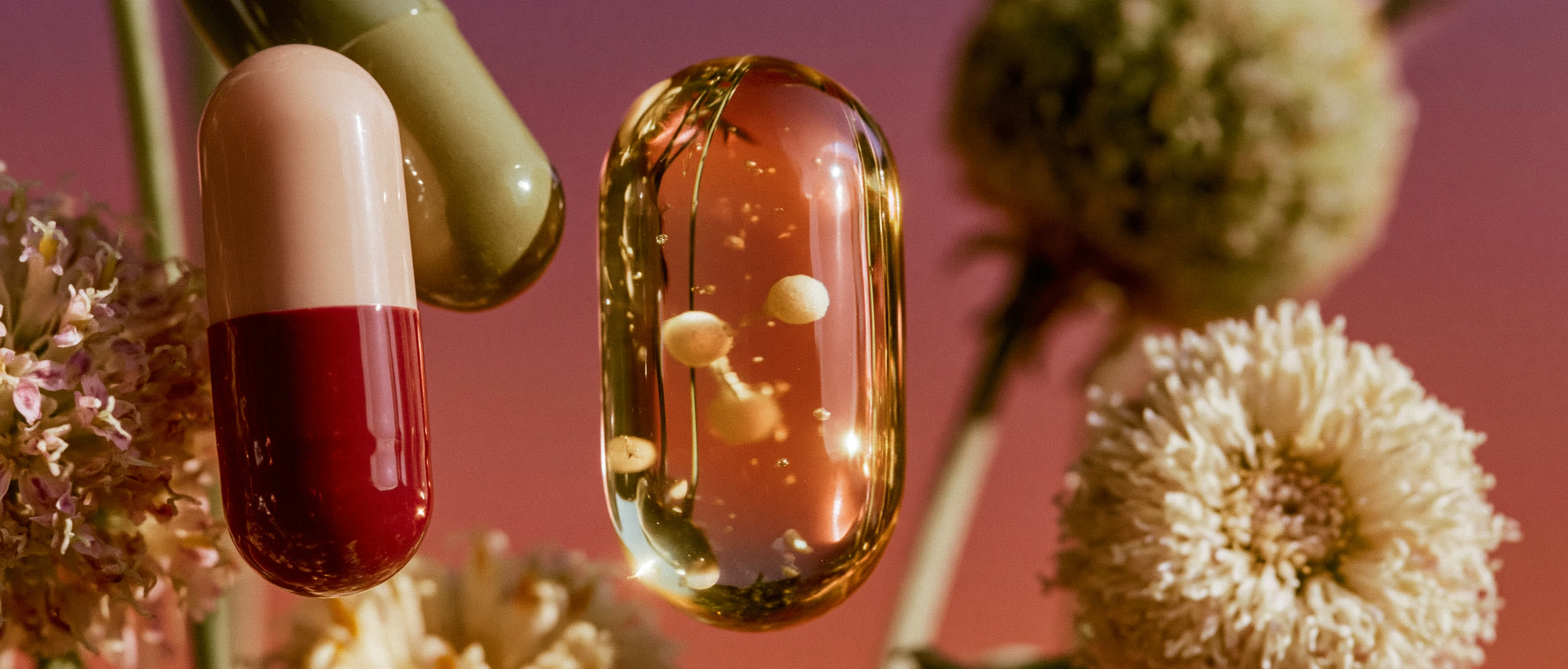 Surreal capsules and flowers in warm pink light
