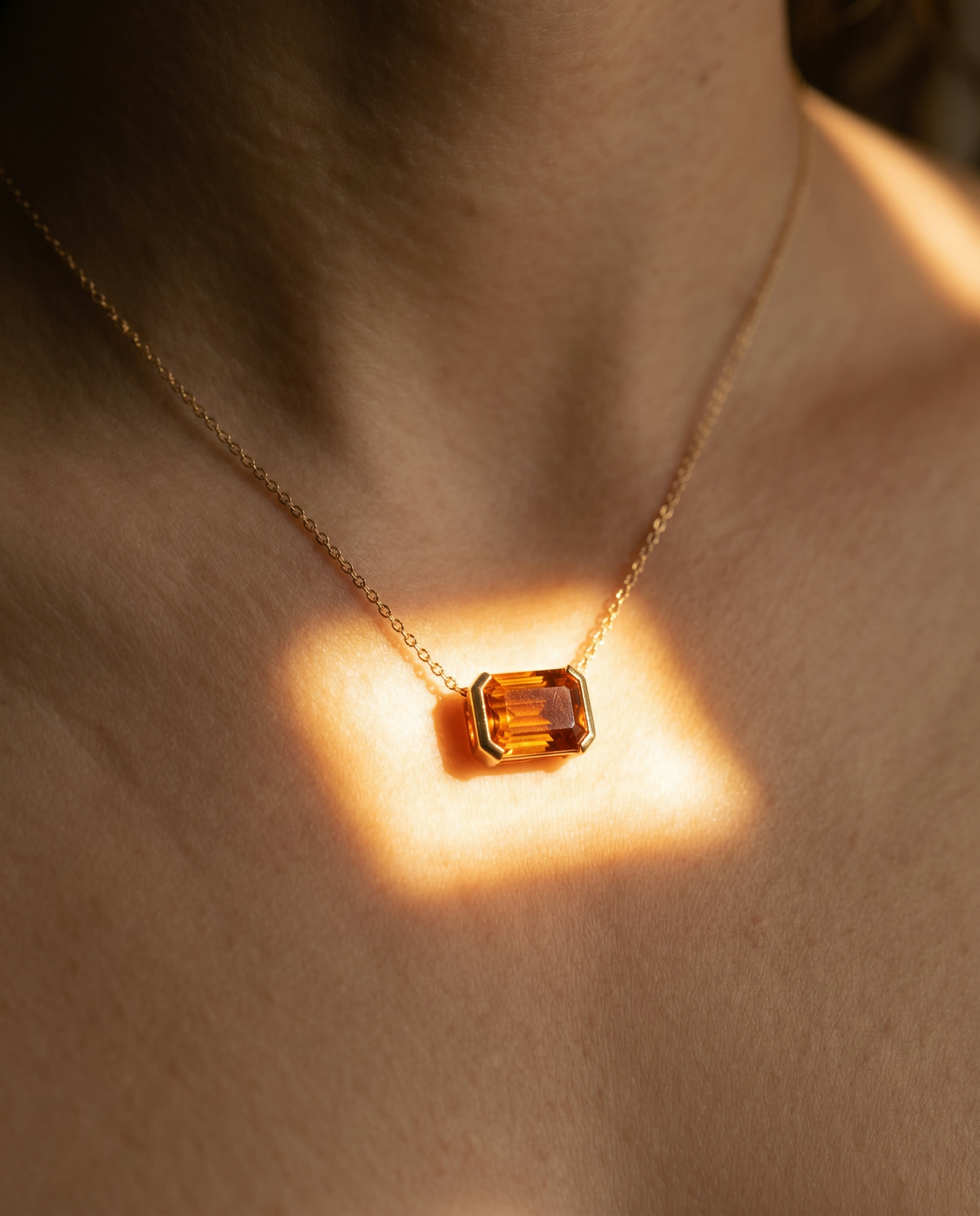 A citrine pendant catching a square of sunlight